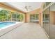 An expansive patio with ceiling fan offers views of the inviting pool area at 17125 Canary Ln, Port Charlotte, FL 33948