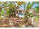 A backyard pool and lanai area surrounded by lush tropical foliage and mature landscaping at 17125 Canary Ln, Port Charlotte, FL 33948