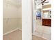 Carpeted walk-in closet leads to an ensuite bathroom with waterfall mural at 17125 Canary Ln, Port Charlotte, FL 33948