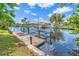 Waterfront with wooden dock featuring a boat lift and picturesque views at 17125 Canary Ln, Port Charlotte, FL 33948