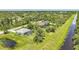Aerial view of two homes, mature trees and landscaping at 1722 Amnesty Dr, North Port, FL 34288
