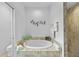 Bathroom featuring a luxurious soaking tub, tiled shower, and elegant fixtures at 1722 Amnesty Dr, North Port, FL 34288