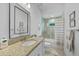 Bathroom featuring granite countertops, framed mirror, tiled shower and tub with curtain at 1722 Amnesty Dr, North Port, FL 34288