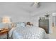 Bright bedroom featuring neutral walls, ceiling fan and comfortable bed with patterned bedding at 1722 Amnesty Dr, North Port, FL 34288