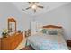 Cozy bedroom features a woven headboard, woven dresser, and colorful bedding at 1722 Amnesty Dr, North Port, FL 34288