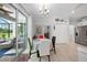 Bright dining area next to the kitchen leading to the screened-in lanai and pool area at 1722 Amnesty Dr, North Port, FL 34288