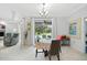 Bright dining area with pool view, chandelier, and access to the outdoor patio at 1722 Amnesty Dr, North Port, FL 34288