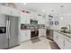 Modern kitchen with stainless steel appliances, granite counters, and sleek white cabinetry at 1722 Amnesty Dr, North Port, FL 34288