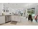 Bright kitchen open to the living room featuring a granite island and stainless steel appliances at 1722 Amnesty Dr, North Port, FL 34288
