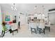 Open concept kitchen featuring granite countertops, white cabinets, and stainless steel appliances at 1722 Amnesty Dr, North Port, FL 34288