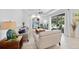 Bright living room features neutral tones, stylish decor, and a view of the outdoor pool area at 1722 Amnesty Dr, North Port, FL 34288