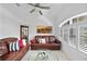 Cozy living room with plantation shutters, crown molding, and comfortable seating at 1722 Amnesty Dr, North Port, FL 34288