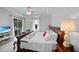Relaxing bedroom featuring a large bed, a view of the pool, and access to the lanai at 1722 Amnesty Dr, North Port, FL 34288