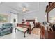 Spacious main bedroom with a comfortable armchair, tray ceiling, and elegant furnishings at 1722 Amnesty Dr, North Port, FL 34288