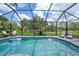 Screened-in pool area offering a serene outdoor space for relaxation and entertainment at 1722 Amnesty Dr, North Port, FL 34288