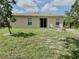 Inviting backyard featuring a well-maintained lawn and a cozy fire pit area at 17344 York Ave, Port Charlotte, FL 33948