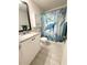 Charming bathroom featuring a decorative shower curtain, vanity, and neutral color scheme at 17344 York Ave, Port Charlotte, FL 33948