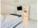 A modern bedroom with a TV, dresser, and easy access to the ensuite bathroom at 17344 York Ave, Port Charlotte, FL 33948