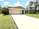 Charming single-story home featuring a well-manicured lawn and a two-car garage at 17344 York Ave, Port Charlotte, FL 33948