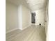 Bright hallway with neutral walls, white trim, and tile floors leading to multiple rooms at 17344 York Ave, Port Charlotte, FL 33948