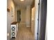 Bright hallway with wood look flooring and a clean, neutral color palette at 17344 York Ave, Port Charlotte, FL 33948