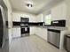 Well-lit kitchen with stainless steel appliances, white cabinets, and black backsplash at 17344 York Ave, Port Charlotte, FL 33948