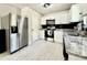 Well-lit kitchen with stainless steel appliances, white cabinetry, and granite countertops at 17344 York Ave, Port Charlotte, FL 33948