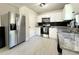 Well-lit kitchen with stainless steel appliances, white cabinets, and granite countertops at 17344 York Ave, Port Charlotte, FL 33948