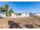 Spacious backyard featuring a modern white home exterior and a sizable open space with a clear blue sky at 175 Rodgers Ne Ave, Port Charlotte, FL 33952