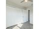 The bedroom features wood-look floors, a ceiling fan, and a closet with white bi-fold doors at 175 Rodgers Ne Ave, Port Charlotte, FL 33952