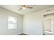 Well-lit bedroom featuring a ceiling fan, air vent and view of hall entrance at 175 Rodgers Ne Ave, Port Charlotte, FL 33952