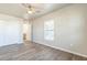 This bedroom features wood-look floors, a window with a view, and a closet with white bi-fold doors at 175 Rodgers Ne Ave, Port Charlotte, FL 33952