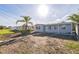 Charming single-story home featuring a partially dirt lawn and mature palm tree in a sunny neighborhood at 175 Rodgers Ne Ave, Port Charlotte, FL 33952