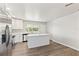 Bright kitchen featuring white cabinets, stainless steel appliances, and a large island with quartz countertops at 175 Rodgers Ne Ave, Port Charlotte, FL 33952