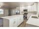 Bright kitchen featuring white cabinets, stainless steel appliances, and a large island with quartz countertops at 175 Rodgers Ne Ave, Port Charlotte, FL 33952