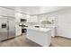 Bright kitchen featuring white cabinets, stainless steel appliances, and a large island with quartz countertops at 175 Rodgers Ne Ave, Port Charlotte, FL 33952