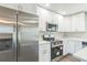 Bright kitchen featuring white cabinets, stainless steel appliances, and quartz countertops at 175 Rodgers Ne Ave, Port Charlotte, FL 33952