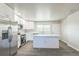 Bright kitchen featuring white cabinets, stainless steel appliances, and a large island with quartz countertops at 175 Rodgers Ne Ave, Port Charlotte, FL 33952