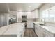 Bright kitchen featuring white cabinets, stainless steel appliances, and a large island with quartz countertops at 175 Rodgers Ne Ave, Port Charlotte, FL 33952