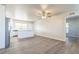An open-concept living area features wood-look floors, stainless steel appliances, and white cabinetry at 175 Rodgers Ne Ave, Port Charlotte, FL 33952
