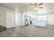 Open-concept living area with wood-look floors, stainless steel appliances, and white cabinetry at 175 Rodgers Ne Ave, Port Charlotte, FL 33952