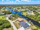 Wide aerial view of a residential area showcasing waterfront homes and scenic canals at 18610 Fort Smith Cir, Port Charlotte, FL 33948