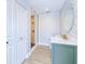 Elegant bathroom with a glass shower, decorative wallpaper, and updated vanity with a round mirror at 18610 Fort Smith Cir, Port Charlotte, FL 33948