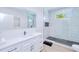 Sleek bathroom features a glass-enclosed shower, marble tiling, and a modern vanity with ample storage at 18610 Fort Smith Cir, Port Charlotte, FL 33948
