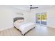 Inviting bedroom boasts natural light, a sliding door to the patio, and neutral decor for a calming retreat at 18610 Fort Smith Cir, Port Charlotte, FL 33948