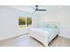 Bright bedroom with hardwood floors, white trim, and large window providing natural light at 18610 Fort Smith Cir, Port Charlotte, FL 33948