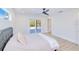 Bright and airy bedroom with easy access to the pool via the sliding glass door and an en suite bathroom at 18610 Fort Smith Cir, Port Charlotte, FL 33948