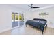 Relaxing bedroom with a sliding glass door and a tranquil view of the landscaped backyard and patio at 18610 Fort Smith Cir, Port Charlotte, FL 33948