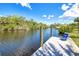 Wooden dock along a waterfront canal featuring a relaxing chair, perfect for enjoying scenic views at 18610 Fort Smith Cir, Port Charlotte, FL 33948