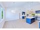 Open-concept layout showcasing kitchen island, pendant lights, and connecting living space, great for modern living at 18610 Fort Smith Cir, Port Charlotte, FL 33948
